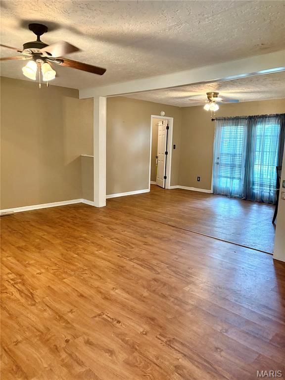 305 Manor, Steele, MO 63877 - spare room with ceiling fan, a textured ceiling, and wood finished floors