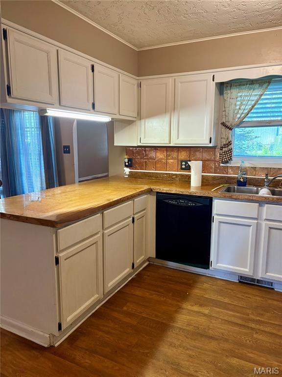 305 Manor, Steele, MO 63877 - kitchen with dishwasher, white cabinets, tasteful backsplash, a textured ceiling, and dark wood-style floors