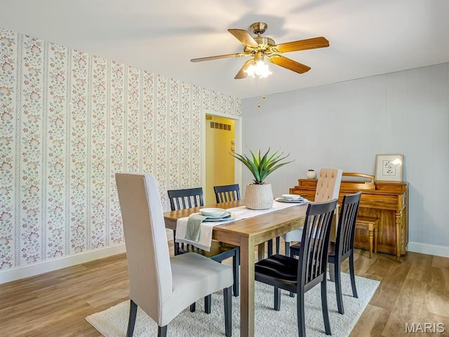 1471 Ladd Ave, Edwardsville, IL 62025 - dining space featuring light wood-style flooring, ceiling fan, and wallpapered walls