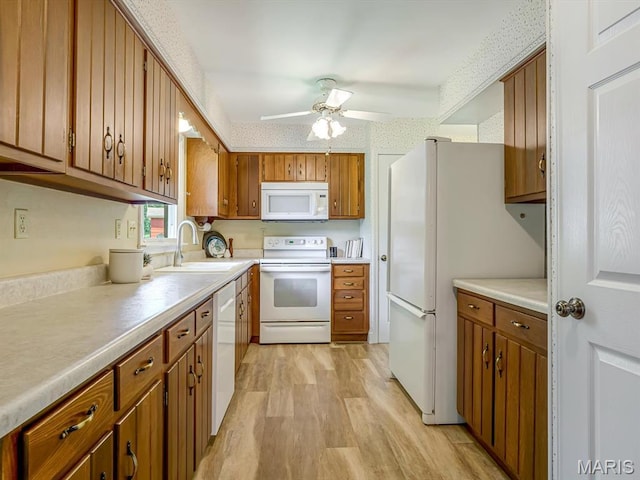 1471 Ladd Ave, Edwardsville, IL 62025 - kitchen with white appliances, light wood-type flooring, a ceiling fan, brown cabinetry, and light countertops