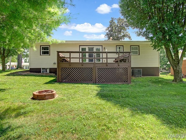 1471 Ladd Ave, Edwardsville, IL 62025 - back of house featuring an outdoor fire pit, a wooden deck, and a lawn