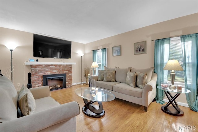 22 Green Acres Rd, Bellefontaine Nghbrs, MO 63137 - living room featuring wood finished floors and a brick fireplace