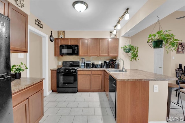 22 Green Acres Rd, Bellefontaine Nghbrs, MO 63137 - kitchen with black appliances, a peninsula, light tile patterned flooring, a breakfast bar, and tasteful backsplash