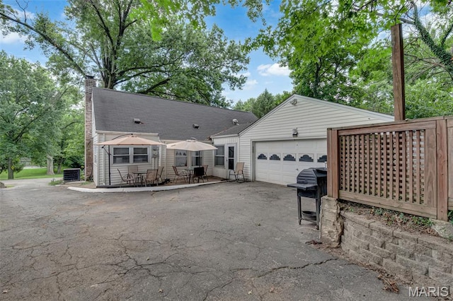 22 Green Acres Rd, Bellefontaine Nghbrs, MO 63137 - view of front of property featuring driveway, a chimney, and an attached garage