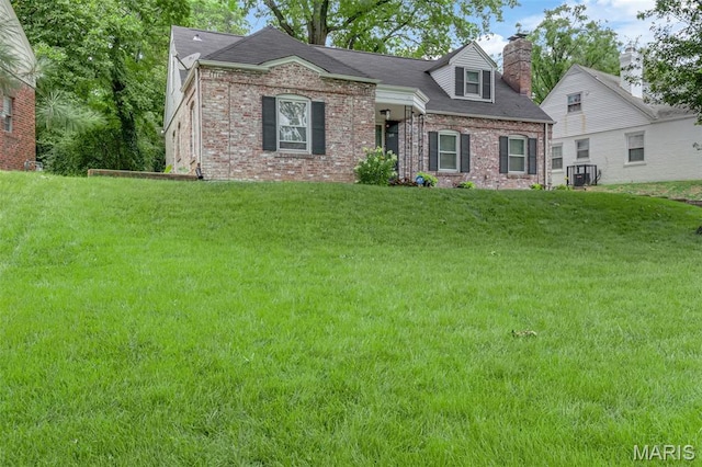22 Green Acres Rd, Bellefontaine Nghbrs, MO 63137 - view of front of home with brick siding, a front lawn, and a chimney