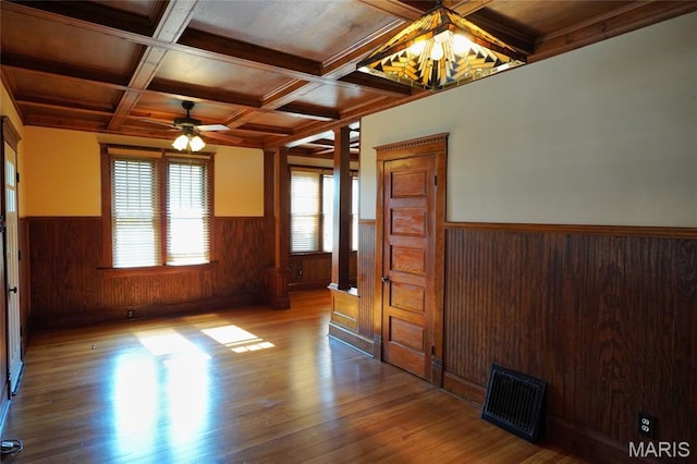 130 E 2nd St, Hermann, MO 65041 - unfurnished room with a wainscoted wall, wood finished floors, wood walls, beam ceiling, and ceiling fan