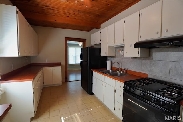 130 E 2nd St, Hermann, MO 65041 - kitchen featuring black appliances, under cabinet range hood, wood ceiling, decorative backsplash, and white cabinets