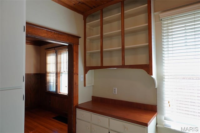 130 E 2nd St, Hermann, MO 65041 - kitchen featuring dark wood-type flooring, white cabinets, a wainscoted wall, wooden walls, and wood ceiling
