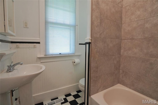 130 E 2nd St, Hermann, MO 65041 - bathroom featuring tile patterned floors and washtub / shower combination