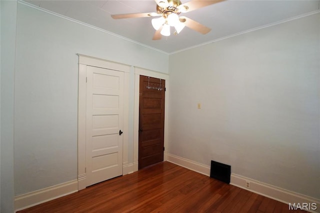 130 E 2nd St, Hermann, MO 65041 - unfurnished room with dark wood-type flooring, ornamental molding, and ceiling fan