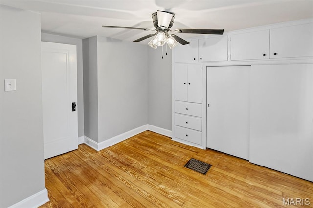 14 S 87th St, Belleville, IL 62223 - unfurnished bedroom featuring light wood-style floors, a closet, and ceiling fan