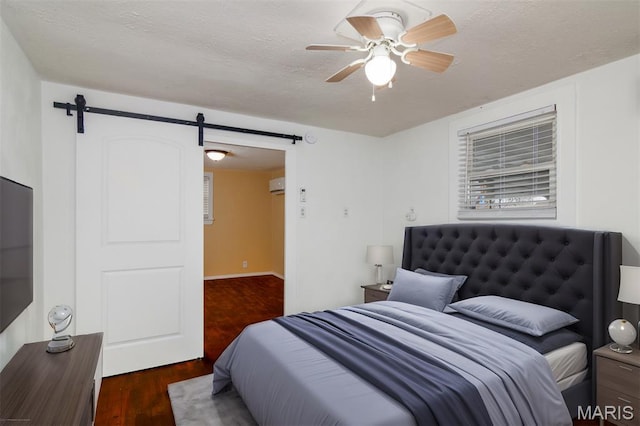 601 E Jefferson St, Ofallon, IL 62269 - bedroom featuring a barn door, wood finished floors, a textured ceiling, and a ceiling fan