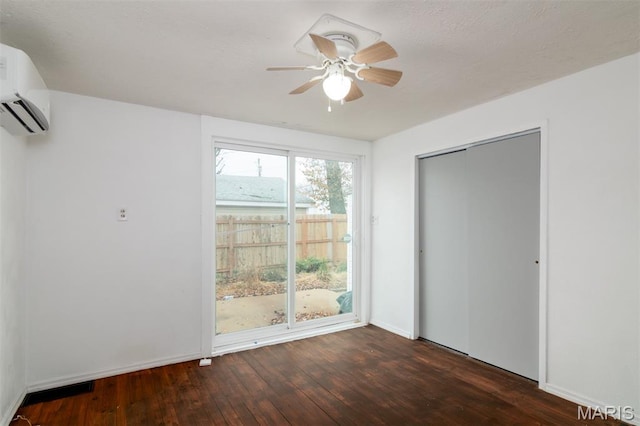 601 E Jefferson St, Ofallon, IL 62269 - unfurnished bedroom with hardwood / wood-style flooring, a wall mounted air conditioner, ceiling fan, and a closet