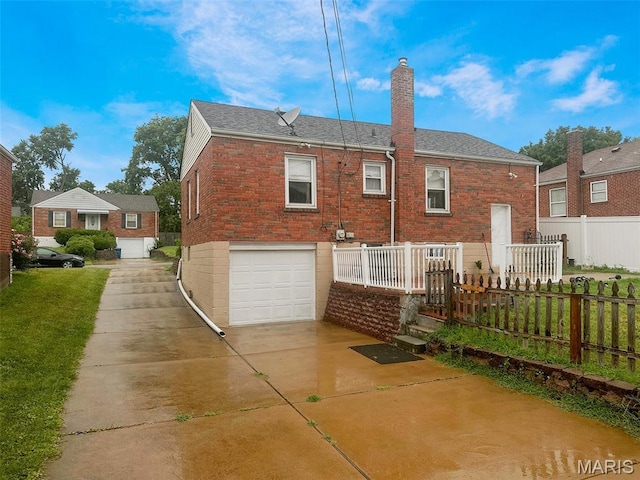 2806 Mohattan Ln, Saint Louis, MO 63125 - back of property with a chimney, driveway, a garage, brick siding, and a shingled roof