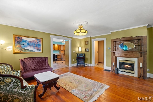 549 E 9th St, Alton, IL 62002 - living room with wood finished floors, crown molding, and a glass covered fireplace
