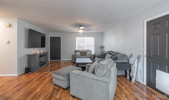 305 Pine Tree Rd, Rolla, MO 65401 - living area with a textured ceiling, wood finished floors, a fireplace, and a ceiling fan