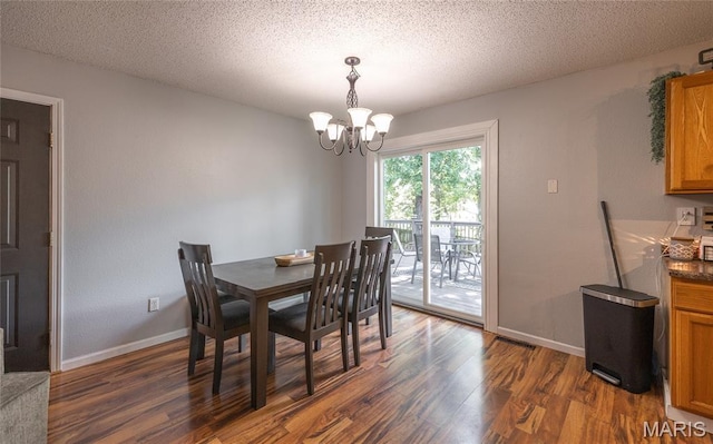 305 Pine Tree Rd, Rolla, MO 65401 - dining area featuring dark wood-type flooring, a chandelier, and a textured ceiling