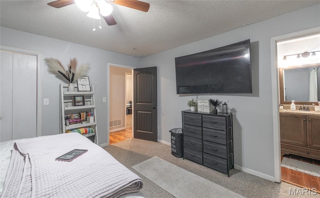 305 Pine Tree Rd, Rolla, MO 65401 - bedroom featuring a textured ceiling, light colored carpet, ensuite bath, and ceiling fan