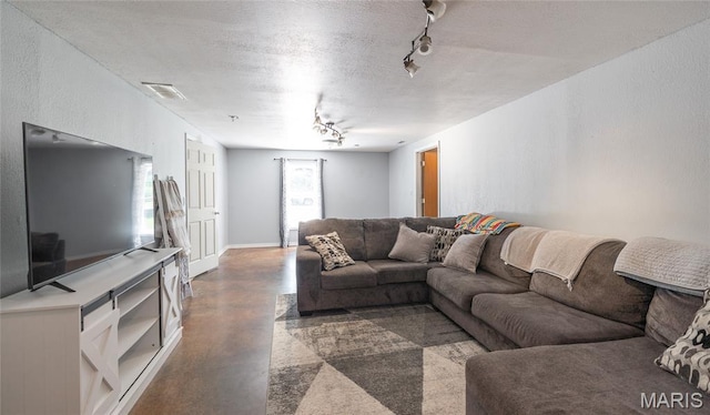 305 Pine Tree Rd, Rolla, MO 65401 - living area with rail lighting, finished concrete floors, and a textured ceiling