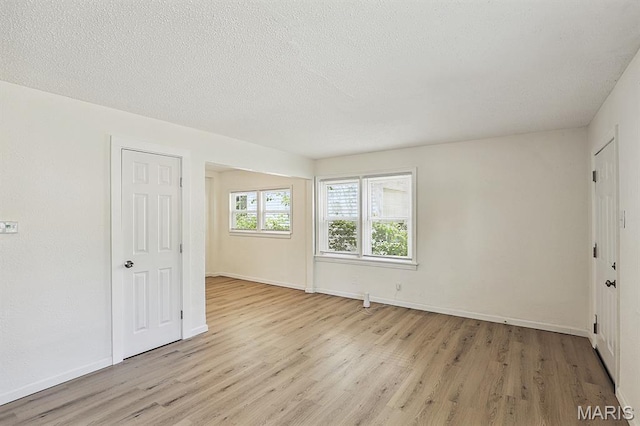 345 Mueller Ave, Ferguson, MO 63135 - spare room featuring light wood finished floors and a textured ceiling