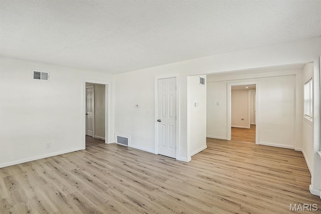 345 Mueller Ave, Ferguson, MO 63135 - empty room featuring wood finished floors and a textured ceiling