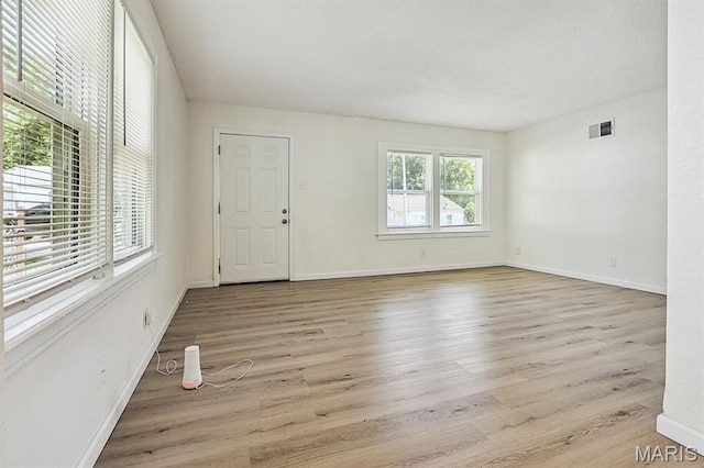 345 Mueller Ave, Ferguson, MO 63135 - unfurnished living room with wood finished floors and a textured ceiling