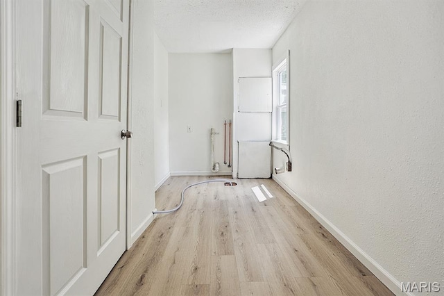 345 Mueller Ave, Ferguson, MO 63135 - spare room with light wood-type flooring and a textured ceiling
