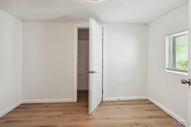 345 Mueller Ave, Ferguson, MO 63135 - spare room featuring light wood finished floors and baseboards