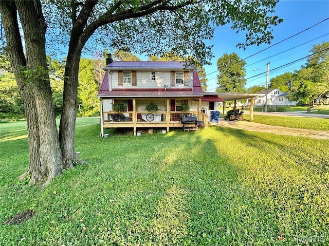 1409 S Washington St, Salem, MO 65560 - farmhouse inspired home featuring a carport, a front yard, a metal roof, covered porch, and a chimney