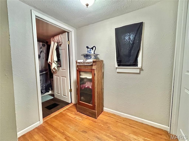 1409 S Washington St, Salem, MO 65560 - hallway featuring a textured ceiling, wood finished floors, and a textured wall