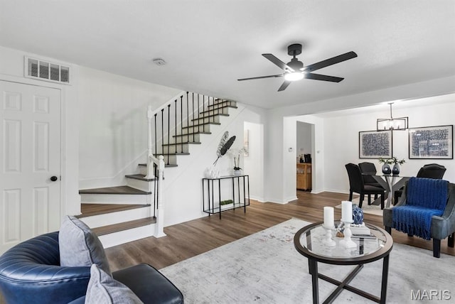 911 Cordova St, Saint Ferdinand Township, MO 63138 - living area featuring stairs, wood finished floors, ceiling fan, and a chandelier