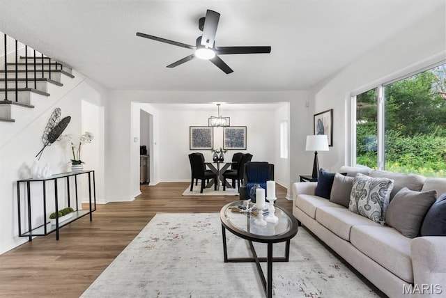 911 Cordova St, Saint Ferdinand Township, MO 63138 - living area with wood finished floors, a chandelier, stairway, and a ceiling fan