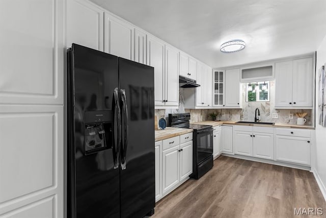 911 Cordova St, Saint Ferdinand Township, MO 63138 - kitchen with black appliances, under cabinet range hood, backsplash, and white cabinetry