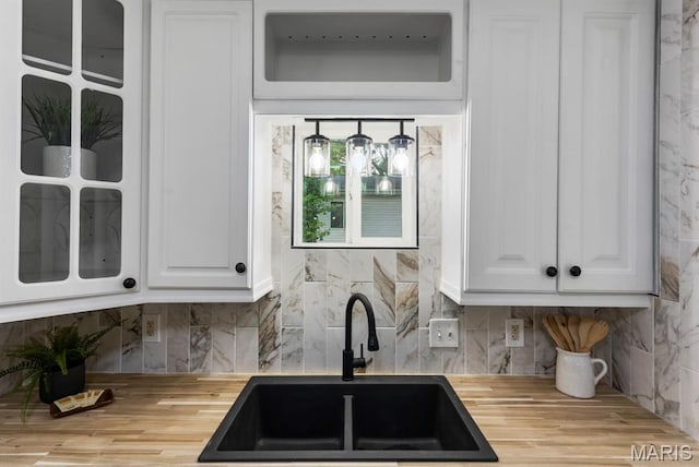 911 Cordova St, Saint Ferdinand Township, MO 63138 - kitchen with butcher block countertops, white cabinetry, and decorative backsplash