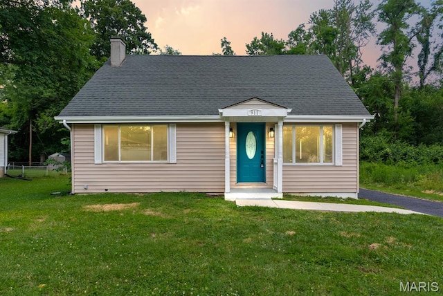 911 Cordova St, Saint Ferdinand Township, MO 63138 - view of front facade with a chimney, a yard, and a shingled roof