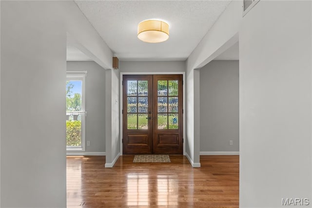 502 Lalor Dr, Manchester, MO 63011 - entryway featuring french doors, wood finished floors, and a textured ceiling