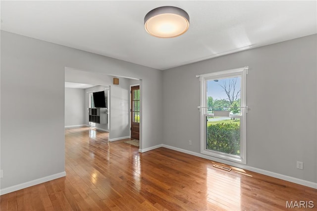 502 Lalor Dr, Manchester, MO 63011 - empty room with healthy amount of natural light and hardwood / wood-style flooring