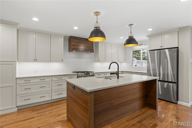 502 Lalor Dr, Manchester, MO 63011 - kitchen featuring stainless steel appliances, custom range hood, decorative backsplash, hanging light fixtures, and recessed lighting