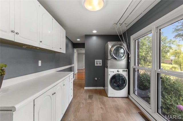 502 Lalor Dr, Manchester, MO 63011 - laundry room featuring stacked washer / dryer, cabinet space, light wood-type flooring, and recessed lighting