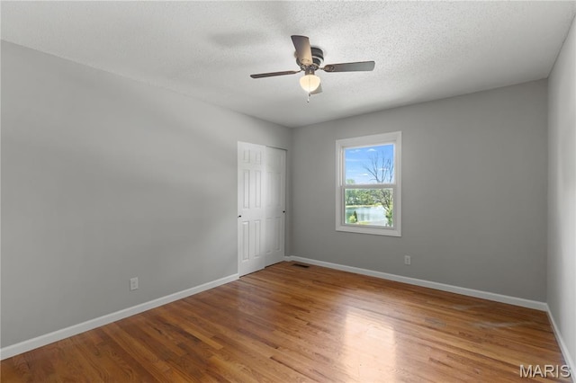 502 Lalor Dr, Manchester, MO 63011 - spare room featuring wood finished floors, a textured ceiling, and ceiling fan