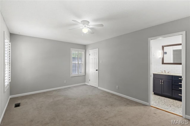 502 Lalor Dr, Manchester, MO 63011 - unfurnished bedroom with light colored carpet, ensuite bath, and ceiling fan