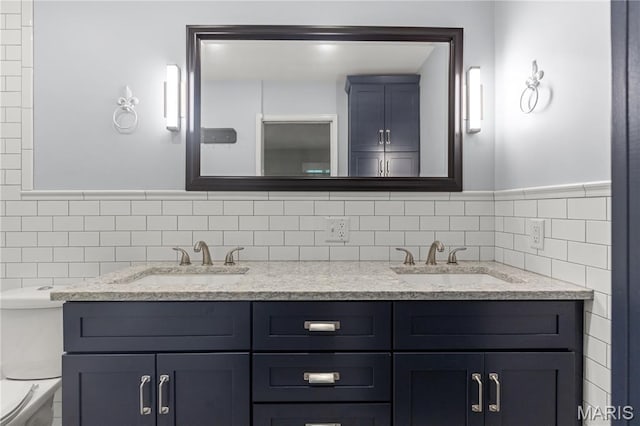 502 Lalor Dr, Manchester, MO 63011 - bathroom featuring double vanity, tile walls, and a wainscoted wall