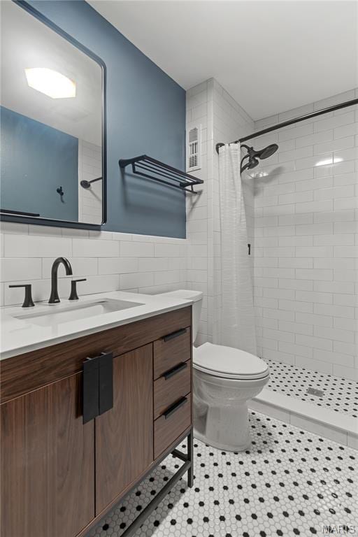 502 Lalor Dr, Manchester, MO 63011 - full bathroom featuring vanity, tile walls, tiled shower, and tile patterned flooring