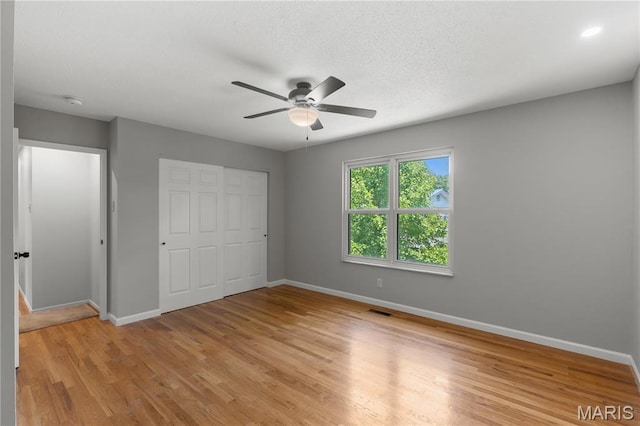 502 Lalor Dr, Manchester, MO 63011 - unfurnished bedroom with a closet, light wood-style floors, and a ceiling fan