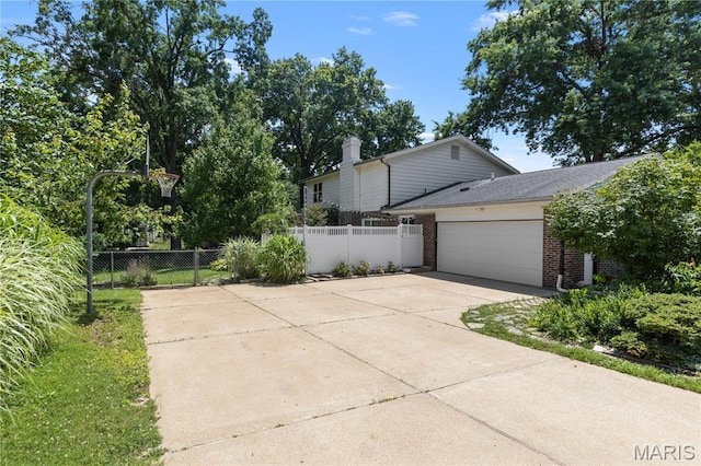 502 Lalor Dr, Manchester, MO 63011 - view of property exterior featuring brick siding, concrete driveway, an attached garage, and a chimney