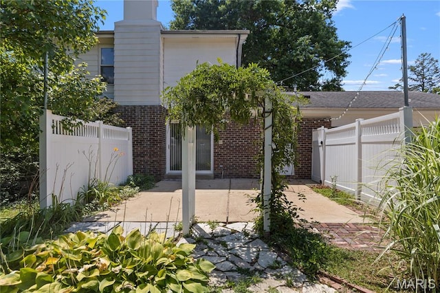 502 Lalor Dr, Manchester, MO 63011 - rear view of house with brick siding, a chimney, and a patio