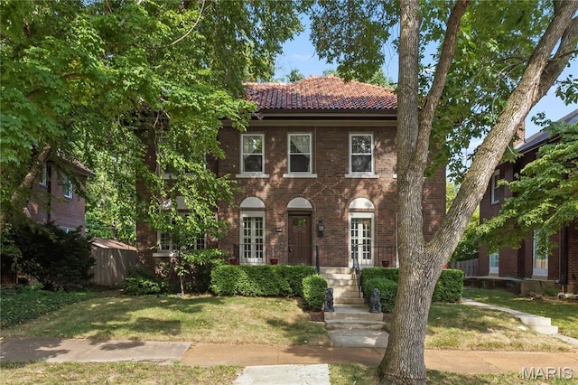 316 Melville Ave, University City, MO 63130 - view of front facade featuring a tile roof, a front yard, and brick siding