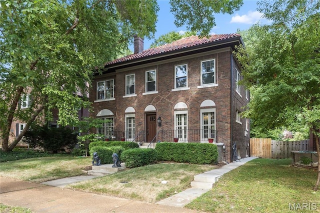 316 Melville Ave, University City, MO 63130 - colonial-style house with a tiled roof, a chimney, and brick siding