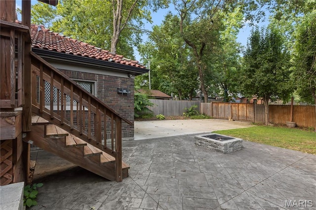 316 Melville Ave, University City, MO 63130 - fenced backyard featuring an outdoor fire pit, a patio, and stairs