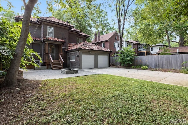 316 Melville Ave, University City, MO 63130 - back of property with a tiled roof, driveway, and an attached garage